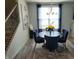 Elegant dining area with blue velvet chairs, a round table, and a decorative light fixture at 6731 Keepsake Dr, Whitestown, IN 46075