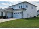 Well-maintained home with a two-car garage, and neatly manicured lawn at 6731 Keepsake Dr, Whitestown, IN 46075