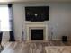 Modern fireplace with decorative accents and a mounted television, creating a cozy atmosphere at 6731 Keepsake Dr, Whitestown, IN 46075