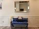 Inviting foyer with a stylish blue bench, decorative pillows, silver vase, and framed mirror at 6731 Keepsake Dr, Whitestown, IN 46075