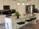 Kitchen featuring stainless steel appliances, a large island, and stylish backsplash at 6731 Keepsake Dr, Whitestown, IN 46075