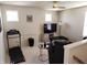 Living room with a TV, treadmill, and a cozy seating area at 6731 Keepsake Dr, Whitestown, IN 46075
