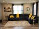 Spacious living room with a large sectional sofa, plush rug, and stylish decor at 6731 Keepsake Dr, Whitestown, IN 46075