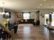 Open-concept living space with a large sectional sofa, dining table, and bar seating at the kitchen island at 6731 Keepsake Dr, Whitestown, IN 46075