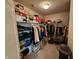 Organized walk-in closet with clothing racks, shoe racks, and storage shelves with many boxes at 6731 Keepsake Dr, Whitestown, IN 46075