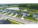 Drone shot of modern homes with well-manicured lawns, located near a pond and golf course, creating a serene neighborhood at 7171 E Rising Sun S Cir, Camby, IN 46113
