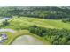High angle view of a scenic golf course, tranquil ponds, and lush green spaces surrounded by beautiful trees at 7171 E Rising Sun S Cir, Camby, IN 46113
