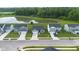 An aerial view showcasing houses near a tranquil pond in a desirable community at 7171 E Rising Sun S Cir, Camby, IN 46113