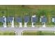 Aerial view of suburban homes with well-manicured lawns, garden beds, and backyard patios along a quiet street at 7171 E Rising Sun S Cir, Camby, IN 46113