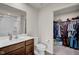 Bathroom featuring a vanity, toilet, and an open walk-in closet at 7171 E Rising Sun S Cir, Camby, IN 46113