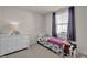 Cozy bedroom featuring neutral walls, carpet, and a comfortable single bed with dresser at 7171 E Rising Sun S Cir, Camby, IN 46113
