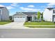 Charming single-Gathering home boasts a well-maintained lawn, a two-car garage, and classic architectural details at 7171 E Rising Sun S Cir, Camby, IN 46113