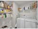 Functional laundry room with a washer, dryer, and plenty of storage shelves at 7171 E Rising Sun S Cir, Camby, IN 46113