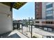 Balcony view overlooking city and street from a modern condominium with wooden floor and metal railing at 721 E North St # 2C, Indianapolis, IN 46202