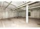 The basement is concrete with exposed piping and painted numbers at 721 E North St # 2C, Indianapolis, IN 46202