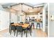 Dining area with modern table, chairs, and open view into kitchen with barstool seating at 721 E North St # 2C, Indianapolis, IN 46202