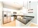 Kitchen features stainless steel appliances, white cabinets and an island with granite countertops at 721 E North St # 2C, Indianapolis, IN 46202