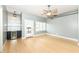 Bright living room features a ceiling fan, wood floors and a convenient wet bar for easy entertaining at 721 E North St # 2C, Indianapolis, IN 46202