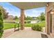 Charming back porch view overlooking a serene pond and well-manicured lawn at 725 Ridge Gate Dr, Brownsburg, IN 46112