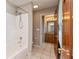 Bathroom with ceramic tile, bath tub, shower head, and light wood cabinetry at 725 Ridge Gate Dr, Brownsburg, IN 46112