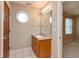 Bathroom featuring tile floors, wood vanity, and a mirror and a circular window for natural light at 725 Ridge Gate Dr, Brownsburg, IN 46112