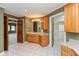 Bathroom featuring tile floors, light-filled vanity, and access to large closet at 725 Ridge Gate Dr, Brownsburg, IN 46112