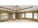 Spacious bedroom with tray ceiling, fan, and generous natural light from multiple windows at 725 Ridge Gate Dr, Brownsburg, IN 46112