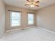 Bright bedroom featuring neutral paint, plush carpet, a ceiling fan, and lots of natural light from dual windows at 725 Ridge Gate Dr, Brownsburg, IN 46112