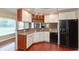 Cozy kitchen with stainless steel appliances, wood cabinets, and backsplash at 725 Ridge Gate Dr, Brownsburg, IN 46112