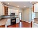 Well-lit kitchen with stainless steel oven and microwave, and a mosaic tile backsplash at 725 Ridge Gate Dr, Brownsburg, IN 46112