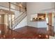 Living room with hardwood floors, staircase and kitchen bar at 725 Ridge Gate Dr, Brownsburg, IN 46112