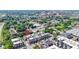 Aerial view of townhomes with a red map pin on the roof, with lush trees and buildings in the distance on a sunny day at 751 Switchyard Pl, Indianapolis, IN 46202