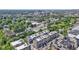 An aerial view of townhomes with neutral exteriors among lush trees and buildings in the distance on a sunny day at 751 Switchyard Pl, Indianapolis, IN 46202