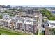 Aerial view of townhomes featuring modern architecture and landscaping in an urban setting, cityscape in background at 751 Switchyard Pl, Indianapolis, IN 46202
