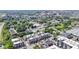 An aerial view of townhomes with neutral exteriors among lush trees and buildings in the distance on a sunny day at 751 Switchyard Pl, Indianapolis, IN 46202