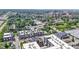 An aerial view of townhomes with neutral exteriors among lush trees and buildings in the distance on a sunny day at 751 Switchyard Pl, Indianapolis, IN 46202