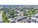 An aerial view of townhomes with neutral exteriors among lush trees and buildings in the distance on a sunny day at 751 Switchyard Pl, Indianapolis, IN 46202