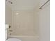 Bright, minimalist bathroom featuring a white tub and shower with neutral-colored tile walls at 751 Switchyard Pl, Indianapolis, IN 46202