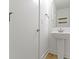 Modern powder room features a pedestal sink, mirror, and a wood-look tile floor at 751 Switchyard Pl, Indianapolis, IN 46202