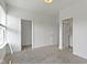 Bright bedroom features neutral carpet, fresh white paint, and doors leading to the closet and bathroom at 751 Switchyard Pl, Indianapolis, IN 46202