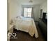 Bright bedroom with a large window and a dark dresser at 751 Switchyard Pl, Indianapolis, IN 46202