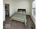 Carpeted bedroom featuring a bed and an adjacent bathroom at 751 Switchyard Pl, Indianapolis, IN 46202