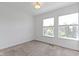 Well-lit bedroom with neutral carpet and two windows providing natural light at 751 Switchyard Pl, Indianapolis, IN 46202