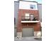 Back exterior view of townhome with brick siding, garage and balcony at 751 Switchyard Pl, Indianapolis, IN 46202