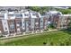 Aerial view showcasing modern townhomes with well-kept lawns and landscaping, fenced perimeter at 751 Switchyard Pl, Indianapolis, IN 46202