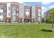 Beautiful townhomes with red brick and gray siding, complimented by a well-manicured lawn at 751 Switchyard Pl, Indianapolis, IN 46202