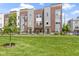 Beautiful townhomes with red brick and gray siding, complimented by a well-manicured lawn at 751 Switchyard Pl, Indianapolis, IN 46202