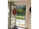 A welcoming view through an open door looking out to a green lawn and fence at 751 Switchyard Pl, Indianapolis, IN 46202