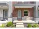 Charming front entrance with concrete steps and landscaping with flowers and green bushes at 751 Switchyard Pl, Indianapolis, IN 46202
