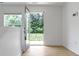 Bright hallway with hardwood floors, white walls, and a glass door to the outside with a window at 751 Switchyard Pl, Indianapolis, IN 46202